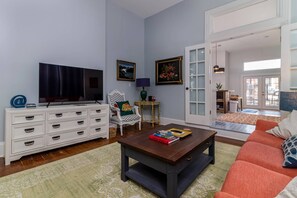 2nd living area with french doors leading into large kitchen