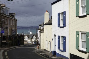 Blue and white ‘Shrimp Cottage’ tucked back just 150m from the bustling harbour.