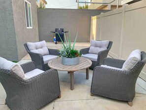 Private outdoor seating area with grill.