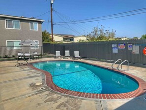 Share swimming pool with lounge chairs.