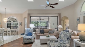 Great room with a view through to the pool and woods