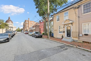 This charming row house is ideally situated directly across the street from Gate 3 of the Naval Academy.