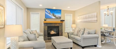 House 2 living room with 2 sofas, gas fireplace and TV