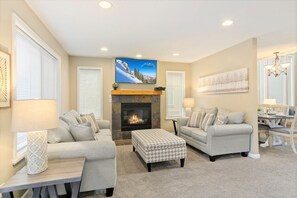 House 2 living room with 2 sofas, gas fireplace and TV