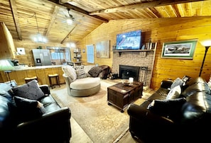 Living Room - 55” Samsung Smart TV, Wood Burning Fireplace, Plenty of Seating.