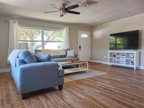 Spacious Front Living Room with 65" Smart TV