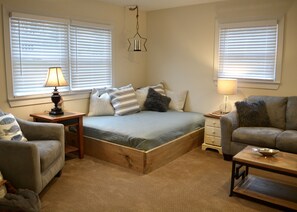 living room features a queen size daybed for lounging or extra sleeping space