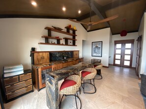 Cocktails at a full bar with beverage center, ice maker & wine storage.