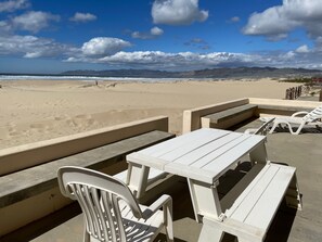 Walk out of the living room onto the spacious, beachfront patio.