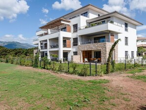 Sky, Plant, Cloud, Building, Window, Land Lot, Vegetation, Urban Design, Facade, Grass