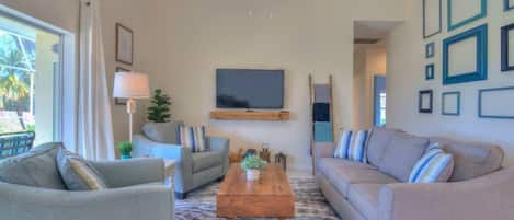 The Family Room is Comfortable and Has a Wall Mounted TV