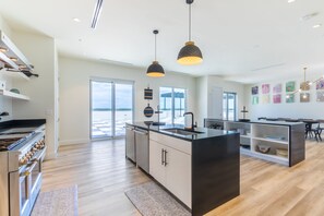 Double island for easy food prep with open shelving.