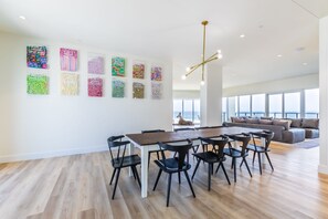 Large dining room table with more seating in the kitchen at the islands.