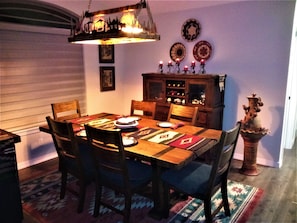 Dine in style on the hand-made reclaimed wood table, surrounded by Mexican art