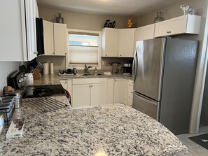 Kitchen with stainless steel appliances. Keurig K-Duo single serve & Carafe.