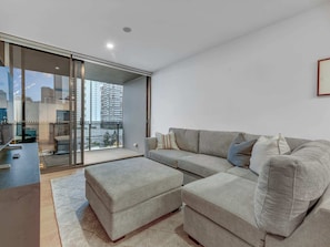 Floor to ceiling glass doors that open up onto the balcony from the living area