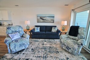 The beautifully decorated living area features gulf views and access to the covered balcony.