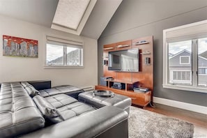 Another view of the living room with tv and comfy couch