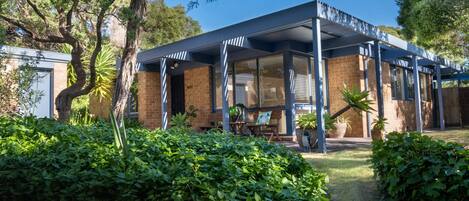 Elevated front view, steps from the carport