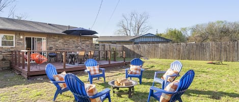 Backyard complete with hammock, yard games, and sprawling patio.