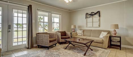 Subtle sophistication in an off-white cream living room, adorned with a cozy beige sofa set, offering comfort in a serene ambiance.