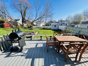 Backyard and deck with brand new grill and sitting area