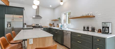 Open Kitchen fully stocked with plates, glassware, flatware, appliances