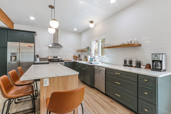 Open Kitchen fully stocked with plates, glassware, flatware, appliances