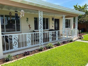 Vintage 1957 front porch with the original railing. Great place to sit and relax