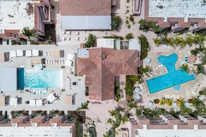 A BIRDS EYE VIEW OF THE SOUTH POOL W/ POOL BAR & NORTH POOL W/ SMALL KIDDIE POOL