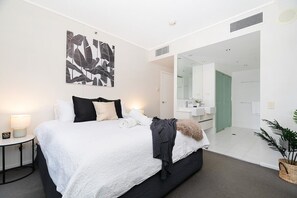 Large master bedroom with king-sized bed and ensuite as well as access to second balcony