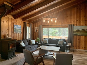 Queen sleeper sofa is under the large window, full sleeper next to the stove.