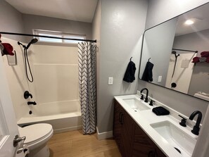 Downstairs bathroom, for family bunkroom and primary, tub area up next to renew!