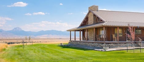 A large mowed lawn surrounds this cabin,  providing  plenty of play space.