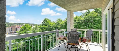 Welcome to Easy Street - Restful views await! This cozy nest, perched amid green trees under blue skies, is perfect for your romantic Smoky Mountain getaway.