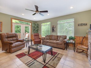 Living Room with a Sofa Sleeper, TV, Fireplace and Balcony Access