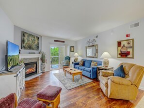 Living Room with Fireplace and Balcony Access