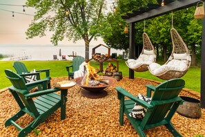 Tell stories and toast s’mores around this unforgettable firepit setup—swing chairs included!