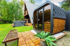 The ultimate unwind: soak in the hot tub or sweat it out in the sauna—just steps from the cabin.