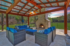 Covered outdoor seating area with fireplace