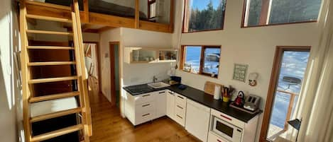 wet bar and king bed in loft area