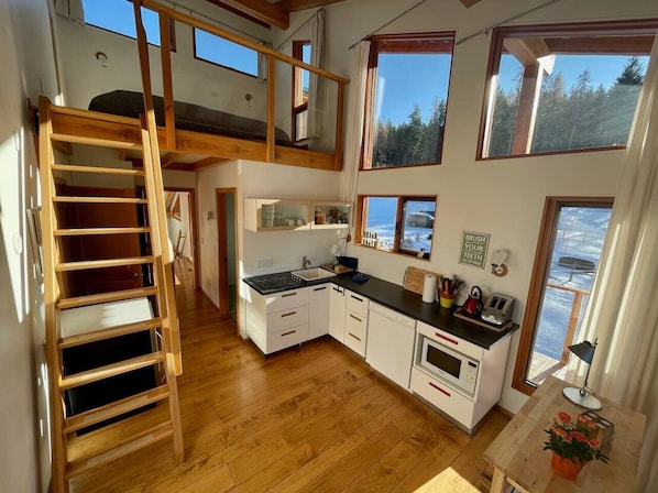 wet bar and king bed in loft area