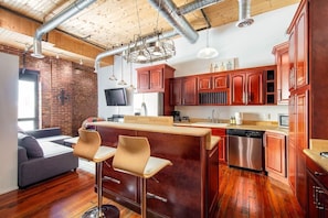 Large kitchen between living and bed area