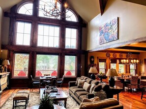 Two story great room with stone fireplace and beautiful lake view