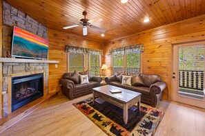 Cozy living room with fireplace, plush couches and 50" HDTV!