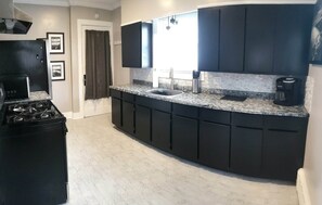 Kitchen, with back door to enter into back mudroom also access back patio