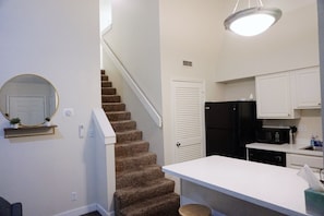 Kitchen w/ stairs to loft area