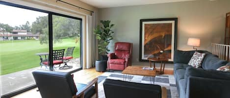 Living room with view of patio on 12th hole