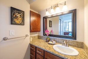 Full bathroom with vanity and a cabinet.