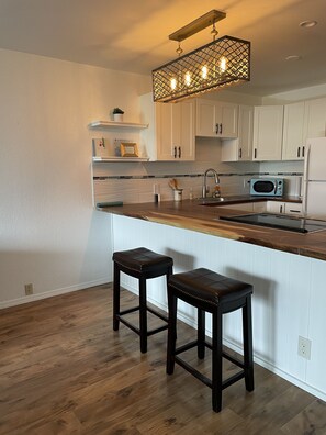 More kitchen area with full size refeigerator.